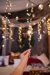 Night background with a star christmas sparkler. Sparkler Bokeh Colorful sparkler. Shallow focus