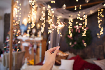 Night background with a star christmas sparkler. Sparkler Bokeh Colorful sparkler. Shallow focus