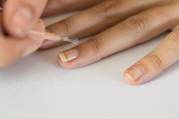 young girl painting her nails