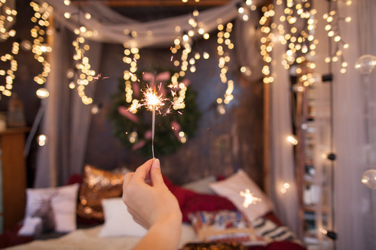 Night background with a star christmas sparkler. Sparkler Bokeh Colorful sparkler. Shallow focus