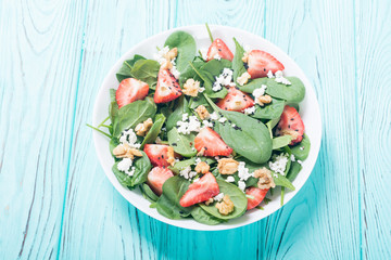 Strawberry salad with spinach , cheese and walnut
