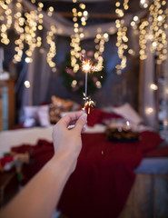 Obraz premium Night background with a star christmas sparkler. Sparkler Bokeh Colorful sparkler. Shallow focus