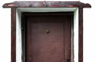 old wooden door with a bronze lion head