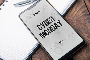 Modern smartphone with "notch" witch cyber monday 2018 banner on the screen. Application on screen created in graphic program