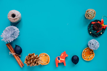 Creative flat lay of christmas ornaments in minimal style with copy space on green background, holiday concept