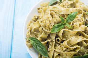 Pasta tagliatelle with green sauce pesto . Italian food background