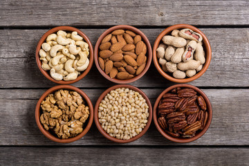 Mix of nuts : Pistachios, almonds , walnuts , pine nut , hazelnuts and cashew . Snack in bowl backgrond