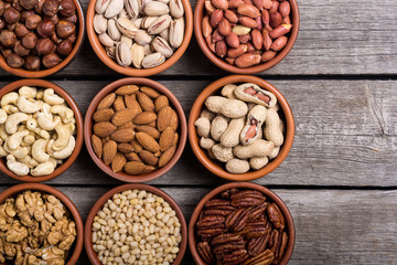Mix of nuts : Pistachios, almonds , walnuts , pine nut , hazelnuts and cashew . Snack in bowl backgrond