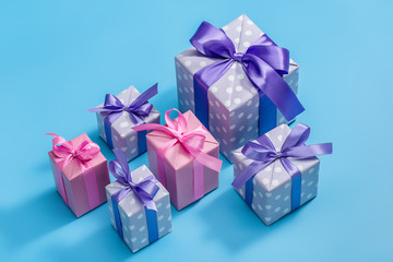 Holiday gifts in colorful boxes with ribbons.