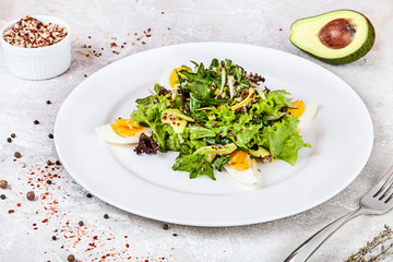 Served quinoa and avocado salad on a light background . Picture for recipes or books. Close up 45 degree view. Copy space for text, logo or brand