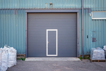 Industrial warehouse with dark grey door for vehicle