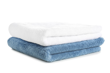 Stack of clean soft towels on white background
