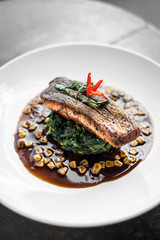 salmon fillet with steamed spinach and corn with soy sauce