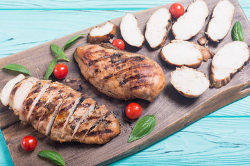 Grilled chicken breast ( fillet ) with basil and tomatoes