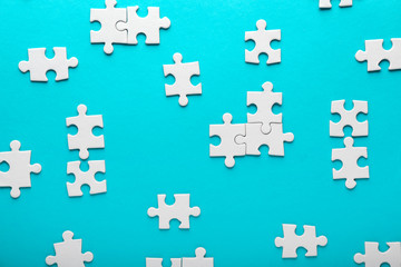 Pieces of jigsaw puzzle on color background