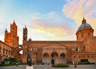 Fototapeta na wymiar The dome of Palermo Cathedral gothic church against warm sunset cloudy blue sky, Sicily, Italy
