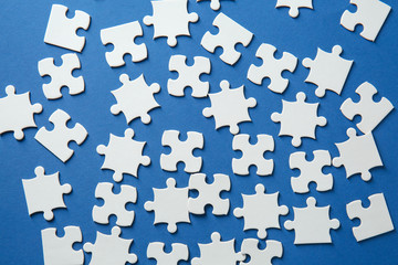 Fragments of jigsaw puzzle on color background