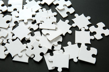 Fragments of jigsaw puzzle on dark background