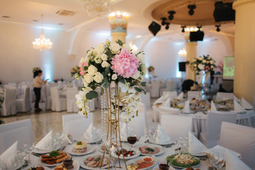 Wedding bouquet in restaurant on the table. Pink and white flowers. Rose and hydrangea