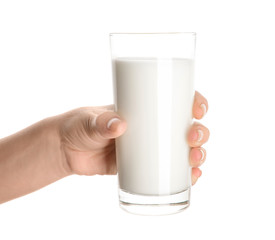Female hand holding glass of tasty milk on white background