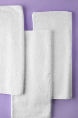 Clean soft towels on color background