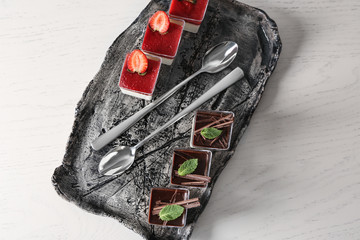 Glasses with tasty panna cotta on plate