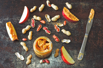 Peanut butter with fresh red apples. Peanuts and peanuts in the peel. The concept of a healthy snack.
