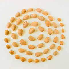 Creative and minimalist composition layout of almonds nuts. Concept- healthy lifestyle, vegetarianism, raw food, vegetable protein.