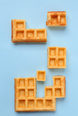 Creative composition with waffles on light background