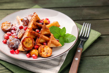 Sweet fresh waffles with fruits on plate
