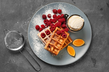 Tasty waffles with berries and ice cream on plate