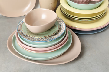 Set of clean dishware on grey table