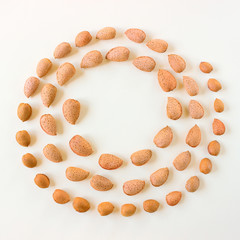 Creative and minimalist composition layout of almonds nuts. Concept- healthy lifestyle, vegetarianism, raw food, vegetable protein.