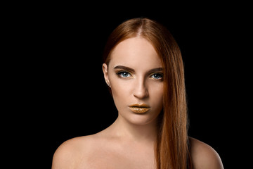 Beautiful woman with golden make up against dark background