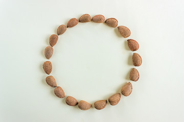 Creative and minimalist composition layout of almonds nuts. Concept- healthy lifestyle, vegetarianism, raw food, vegetable protein. Copy space.