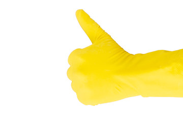 Fototapeta na wymiar Gesture by a thumb in a yellow rubber glove on a white background. A hand in a yellow latex glove shows a thumbs up gesture on a white background. Gesture Excellent, shown with a yellow rubber glove.