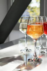 Glasses of tasty wine on table