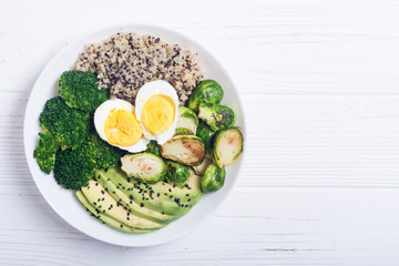 Buddha bowl with quinoa , eggs , avocado , brussels sprouts and broccoli