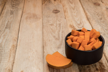 Pumpkins with fall leaves over wooden background. Top view.