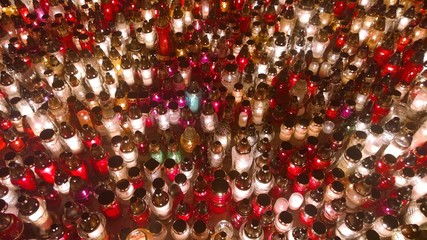 Lots of colourful grave candles shining at night