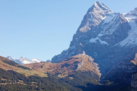Sunny autumnal view of Eiger glacier (Eigergletcher), Wengernalp and train from Kleine Scheidegg, from Muerren (M&uuml;rren), Jungfrau Region, Switzerland
