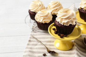 Tasty chocolate cupcakes on white table