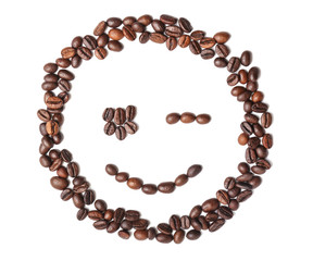Funny smiling face made of roasted coffee beans on white background