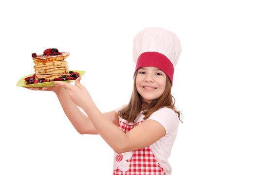 happy beautiful little girl cook with american pancakes