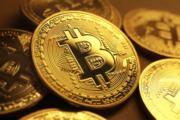 Golden bitcoins on table, closeup