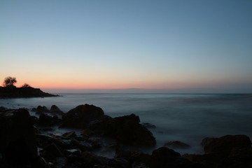 Mysterious sunset in a rocky coast 