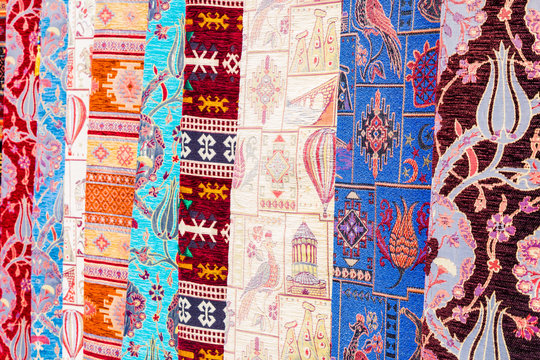 Beautiful multicolored handmade carpets are in the store for sale. Many color patterns and symbols are embroidered by hands. Beautiful images on carpets is the national art of Turkey.