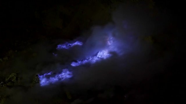 Blue flame of burning sulfur at the Ijen volcano complex, East Java, Indonesia.