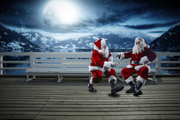 Red old Santa Claus and winter night. Landscape of mountains and lake. Free space for your decoration. Moon light . 