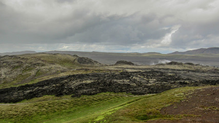 Fototapeta premium Steaming lava fields of Krafla volcanic system, located north of Lake Myvatn in North Iceland, Europe